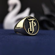 A masterfully crafted 14K gold ring featuring engraved initials that unite name and surname in a bold, monogrammed seal. Its weighty presence and fine details reflect true artisanal work. This personalized gold ring is a luxurious piece that stands out as a symbol of heritage, love, or personal power.